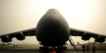 a large black airplane on a runway
